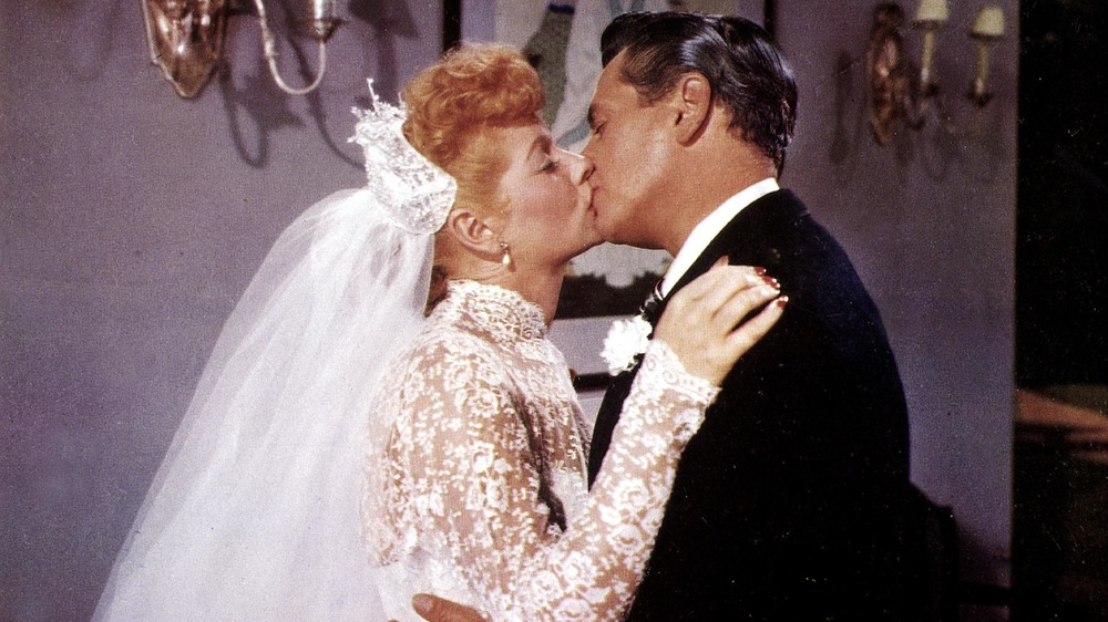 Lucille Ball and Desi Arnaz kissing after wedding vows