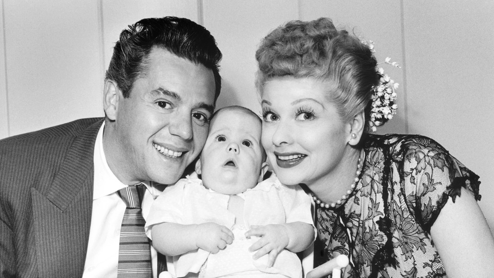  Desi Arnaz and Lucille Ball pose with their son