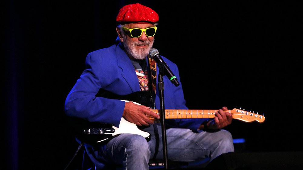 Tommy Chong playing guitar