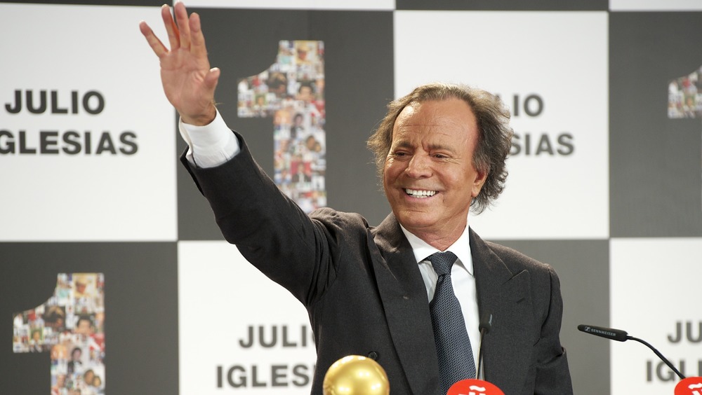 Julio Iglesias with hand raised