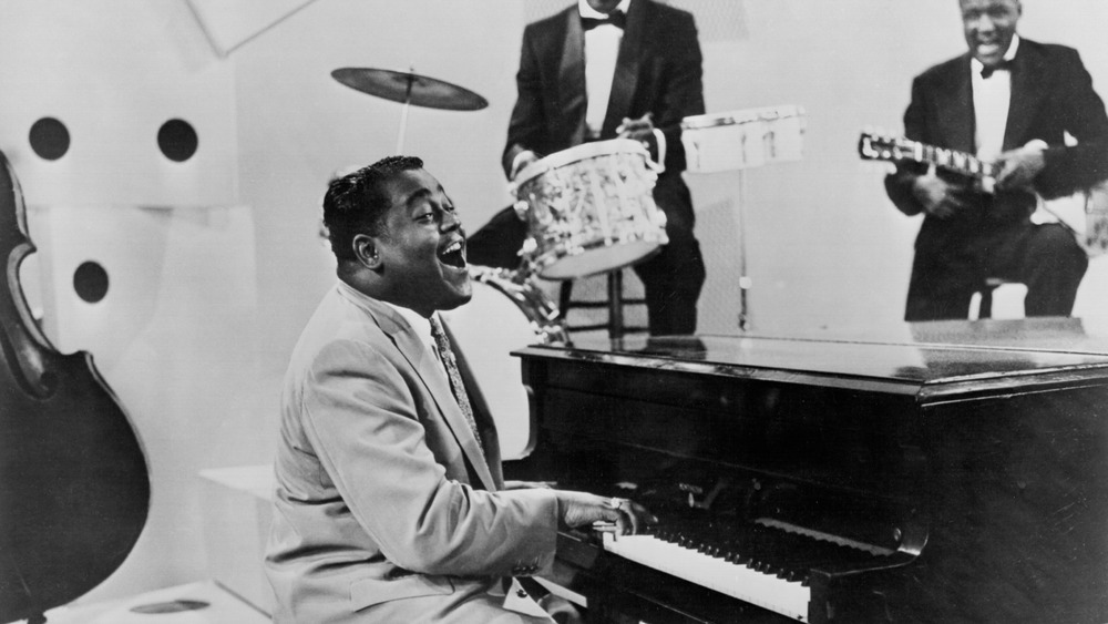 R&B singer and pianist Fats Domino performs on a TV show circa 1958