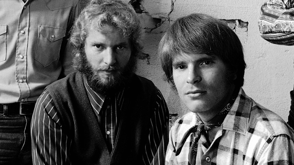 Tom Fogerty and John Fogerty staring at camera