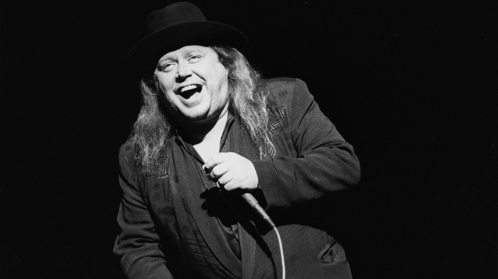 Stand-up comedian and actor Sam Kinison is shown performing on stage during a 