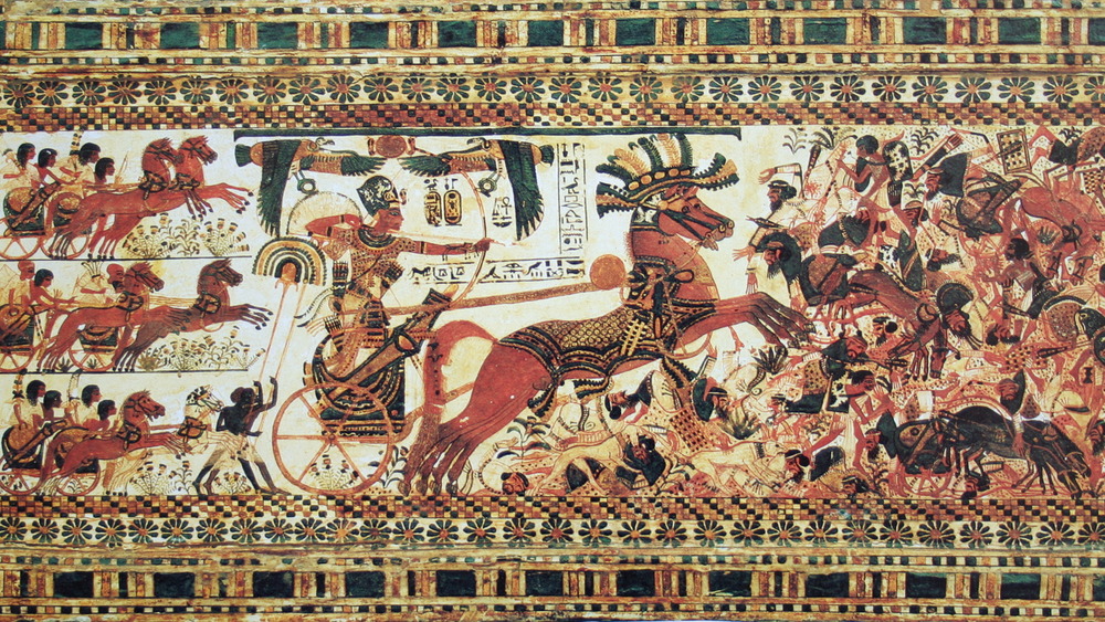 Hieroglyph of Tutankhamun destroying his enemies in a horse-drawn chariot