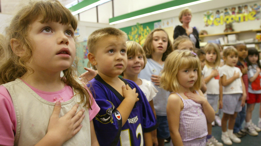 A kindergarten class performs the Pledge of Allegiance 