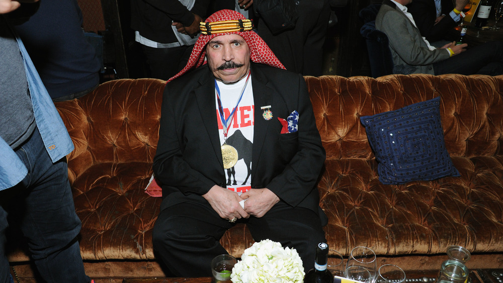 The Iron Sheik sitting on a couch