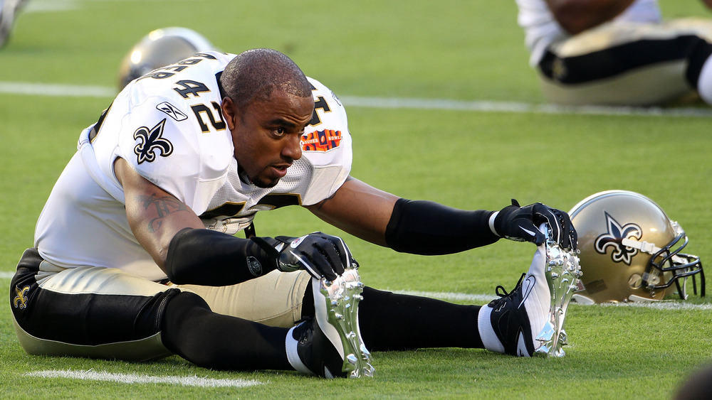 Darren Sharper stretching legs on the field