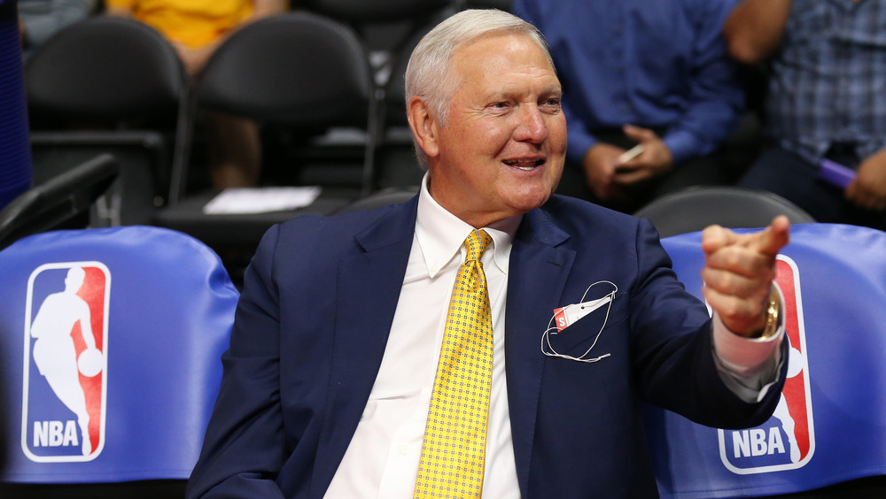 Jerry West sitting with finger pointing