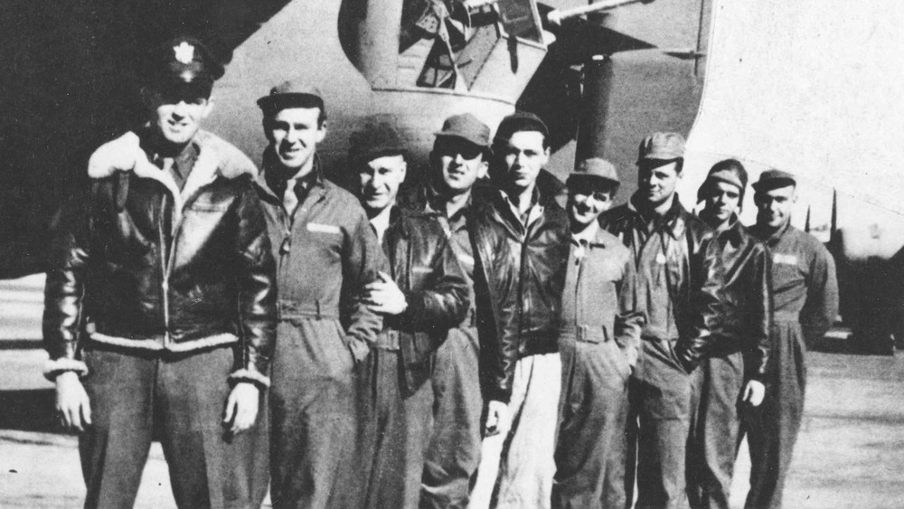 The crew standing in front of plane