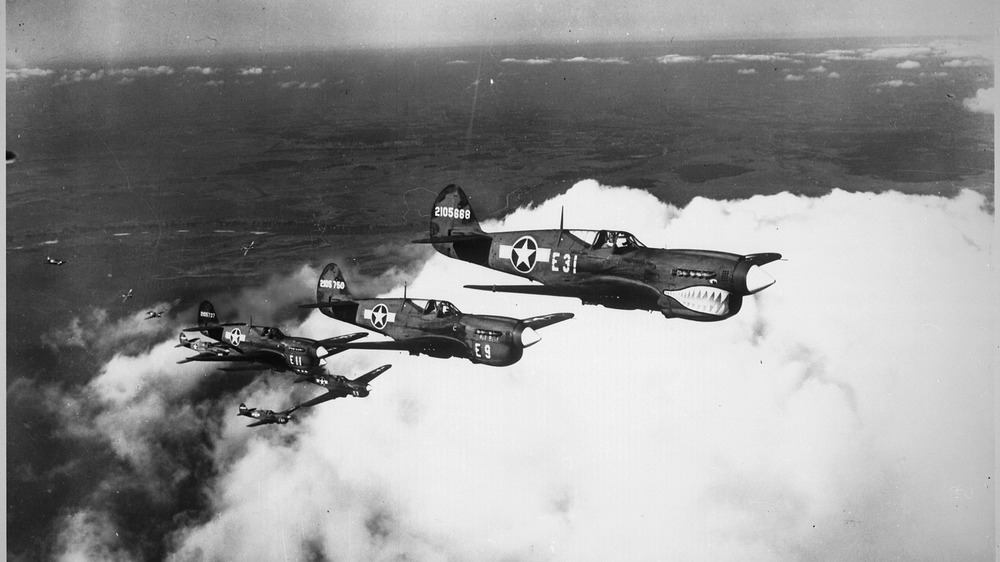 P-40 warhawks flying above clouds