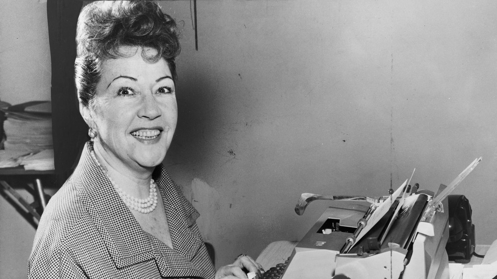 Actress Ethel Merman sitting at a typewriter