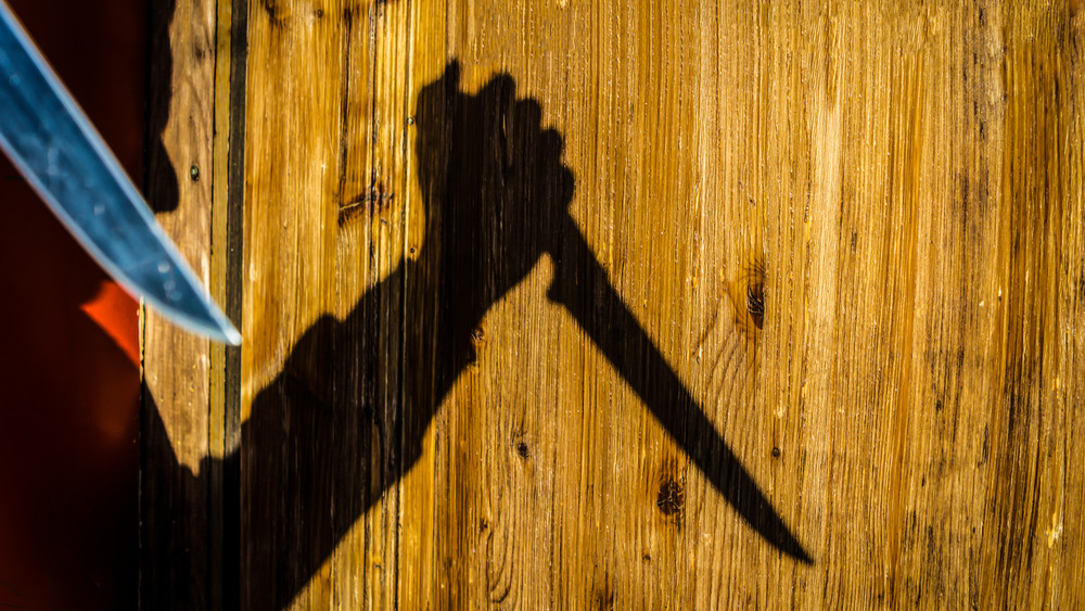 shadow of a killer with knife