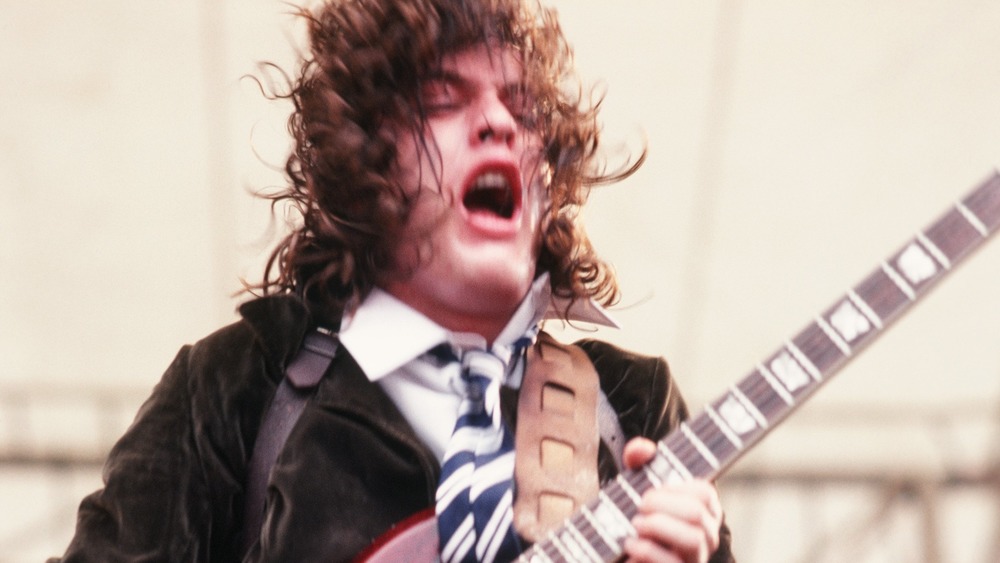 Angus Young of AC/DC playing guitar