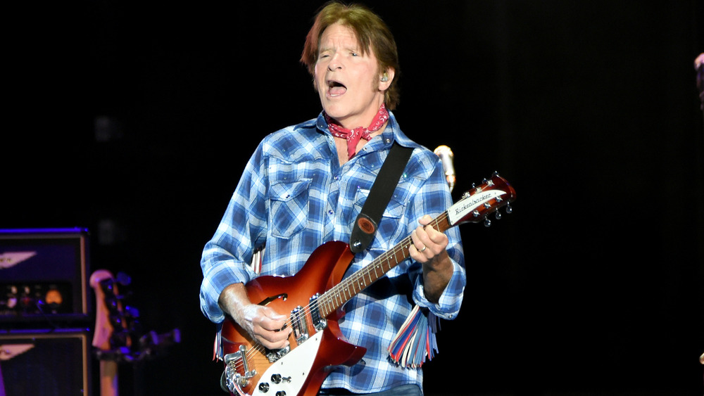 Fogerty singing and playing guitar