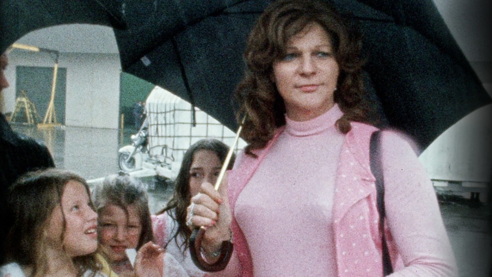 Elizabeth Carmichael holding an umbrella