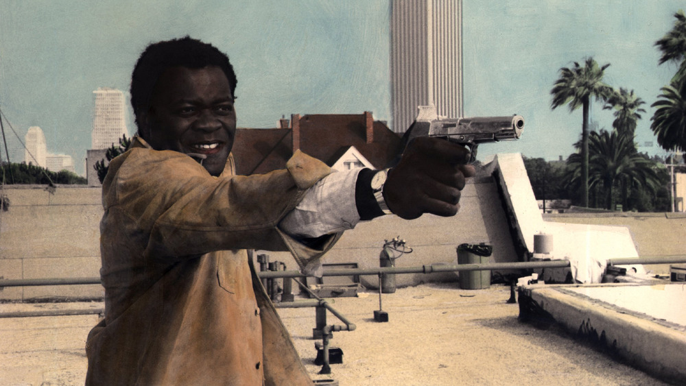 Yaphet Kotto  holding a gun