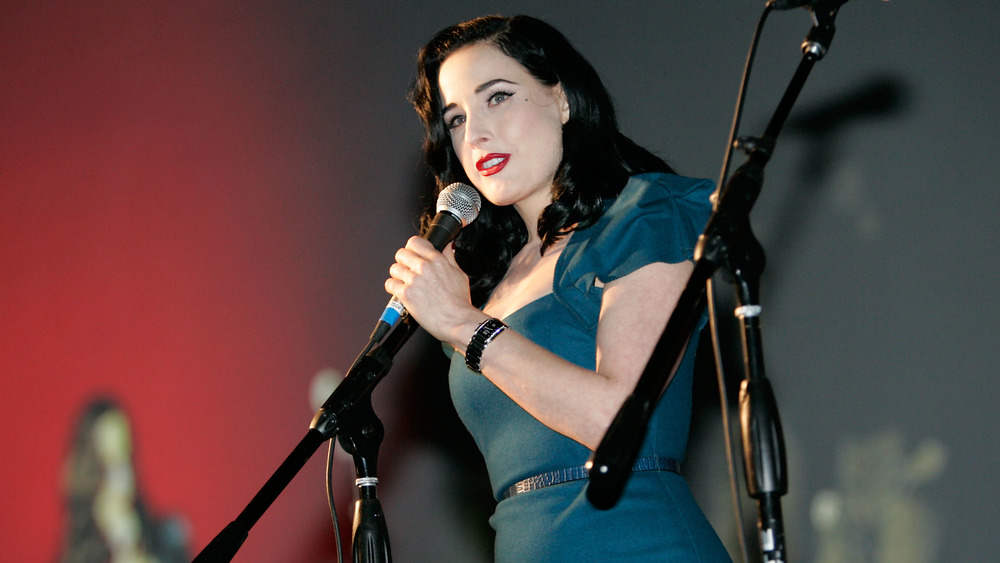 Dita Von Teese with microphone