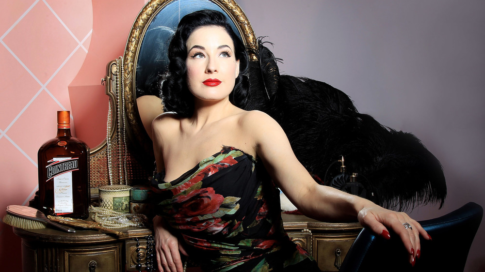 Dita Von Teese sitting and leaning back