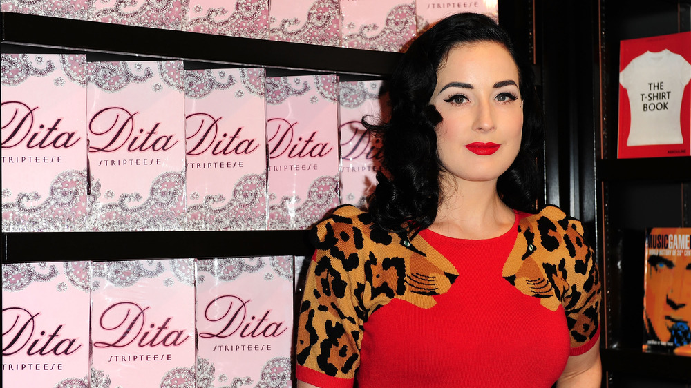 Dita Von Teese with copies of her book