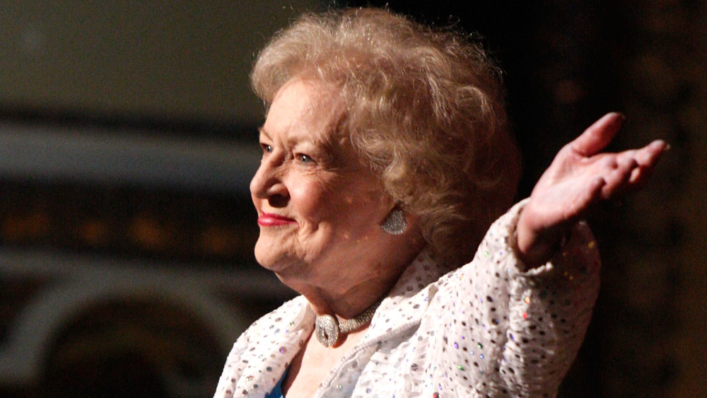Betty White smiling with hand in air