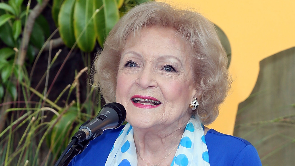Betty White speaking at a microphone