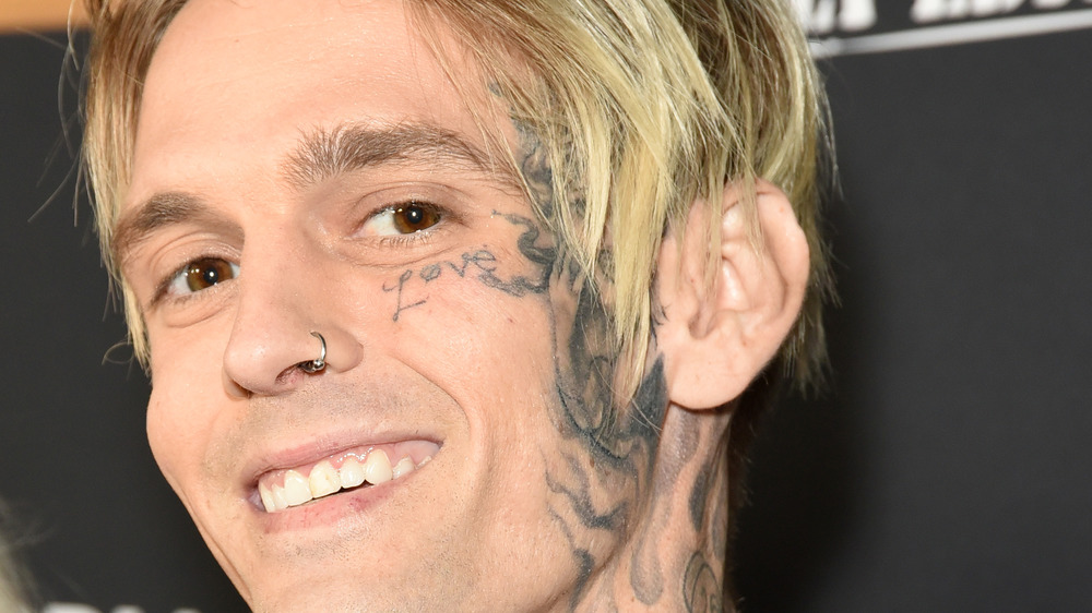 Aaron Carter, smiling with tattoos