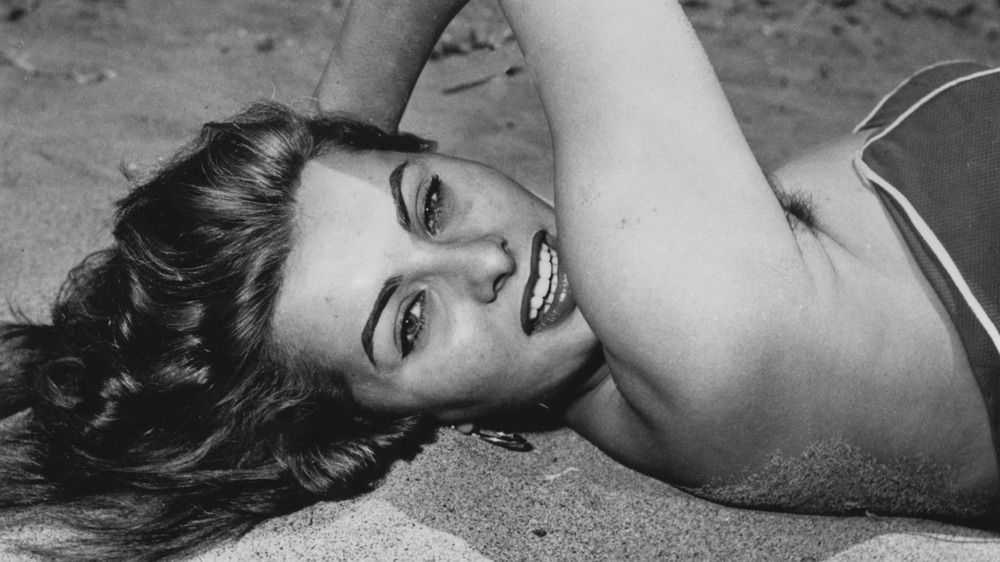 Sophia Loren lying on the beach