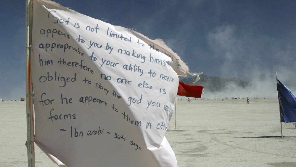 A flag flying with words on it