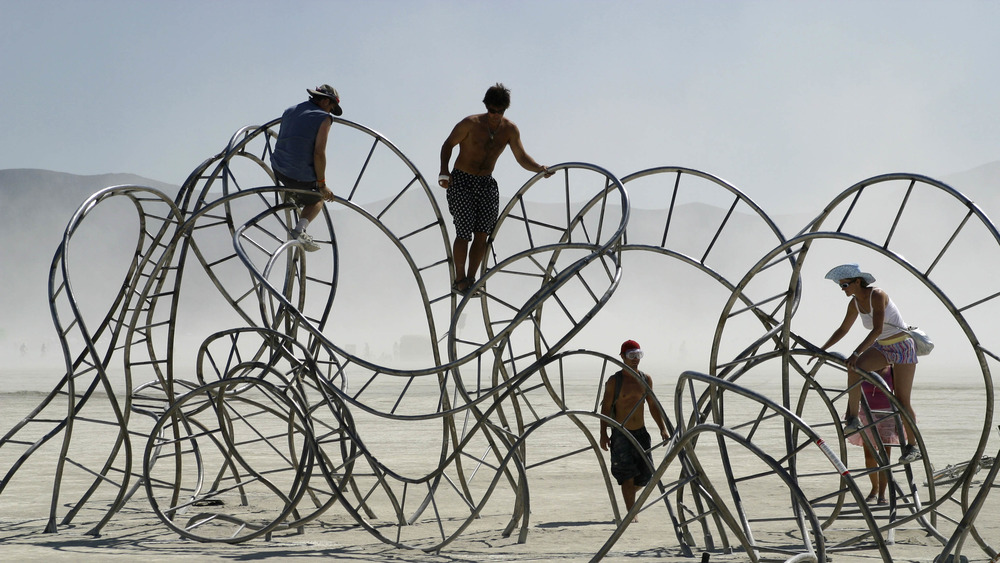 people on a giant wire sculpture
