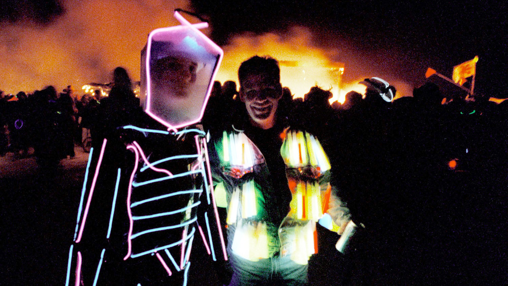 festival-goers in lit costumes