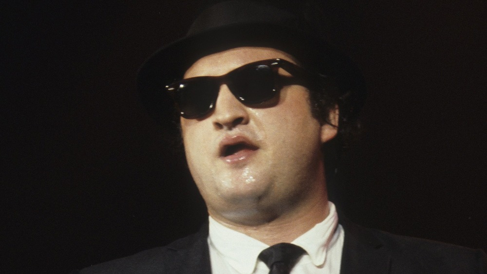 John Belushi as a Blues Brother wearing sunglasses