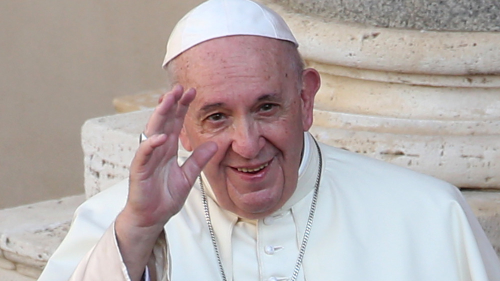 Pope Francis smiles and waves