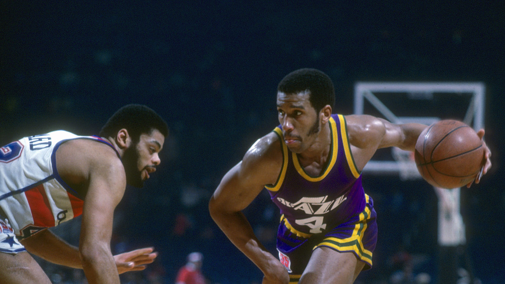 Adrian Dantley dribbles a basketball