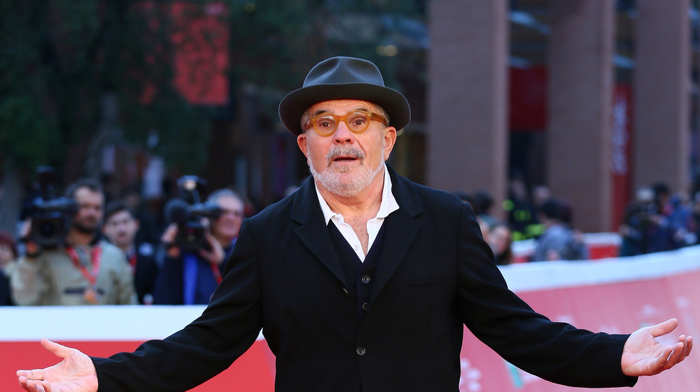 David Mamet with his arms out
