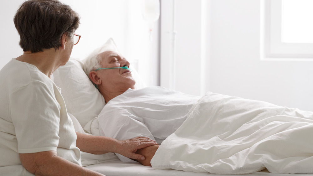 Wife holding patient's arm