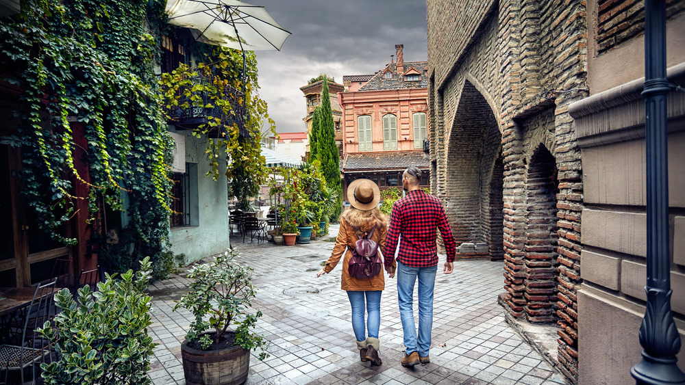 couple walking through medieval city
