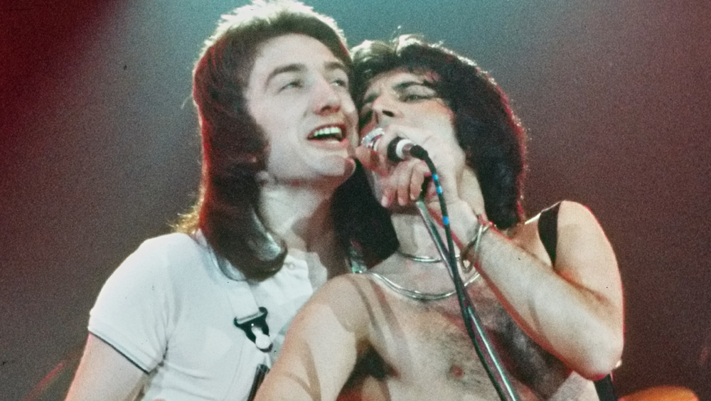 John Deacon on stage with Freddie Mercury