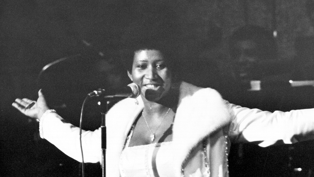 Aretha Franklin with arms raised