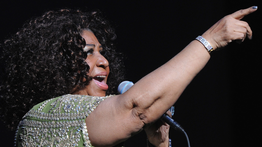 Aretha Franklin with arm raised