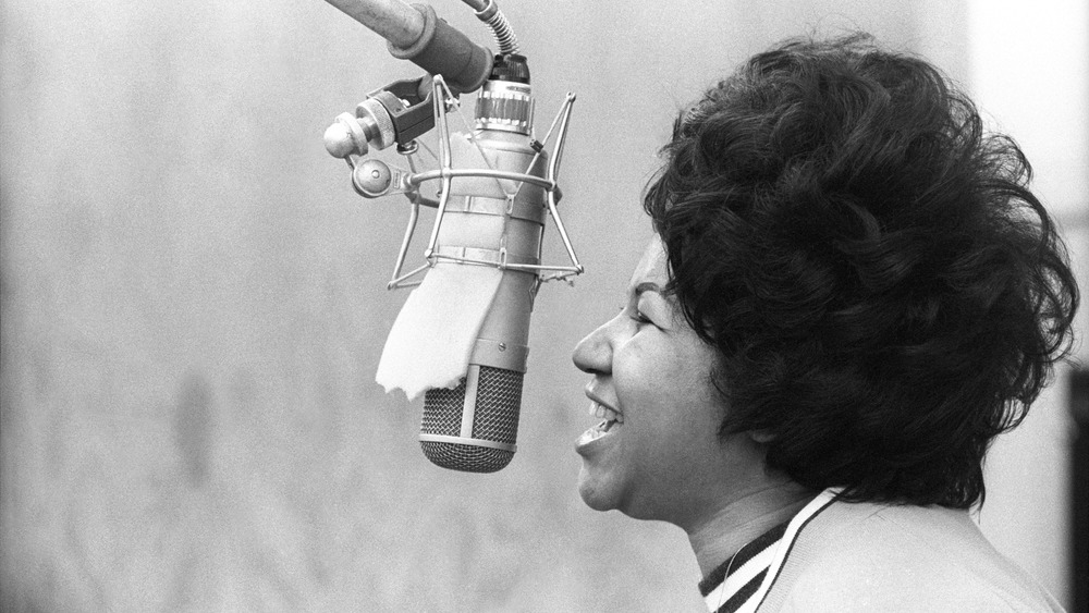 Aretha Franklin singing at mic