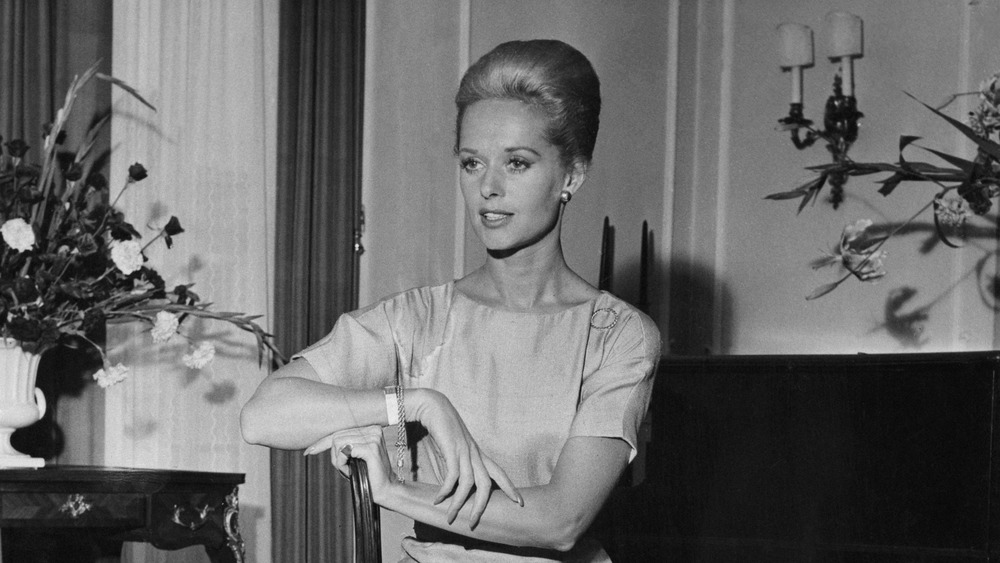 Tippi Hedren seated, with arms folded