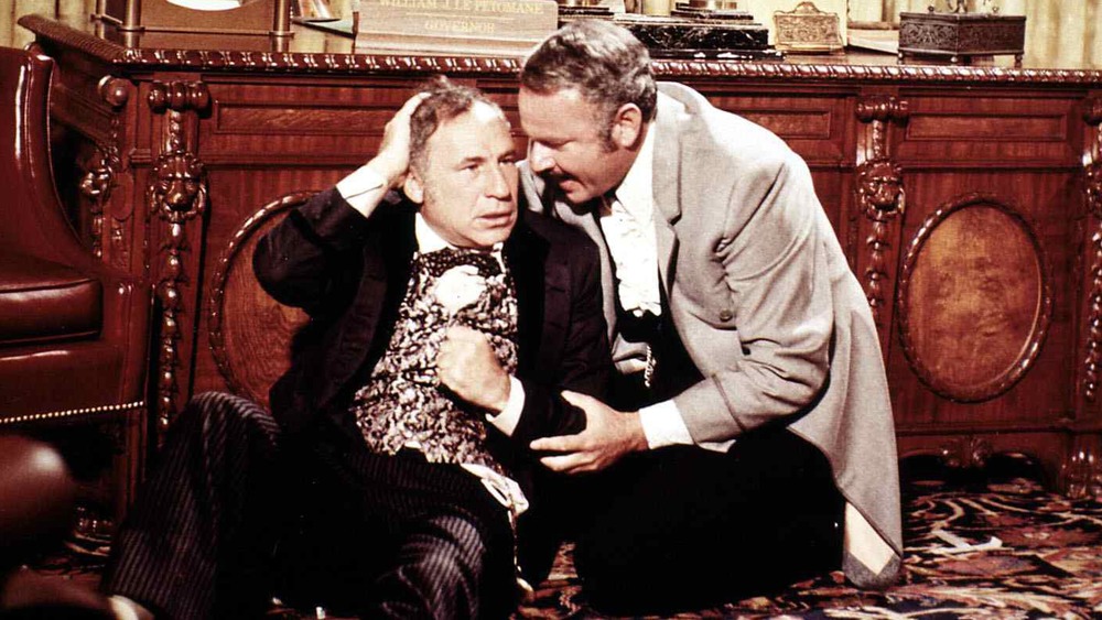 Mel Brooks and Harvey Korman sitting on ground