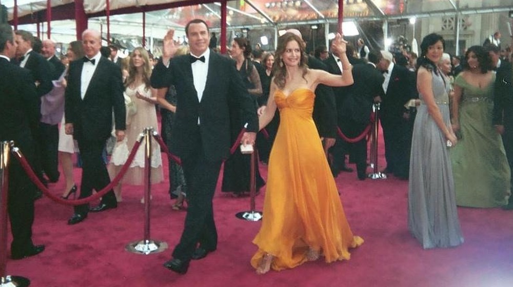 Kelly Preston and John Travolta waving