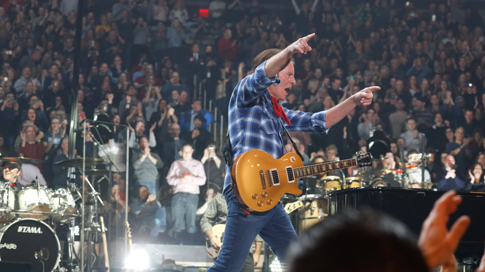 John Fogerty performing in front of a huge crowd