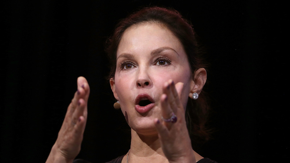 Ashley Judd speaking with hands raised