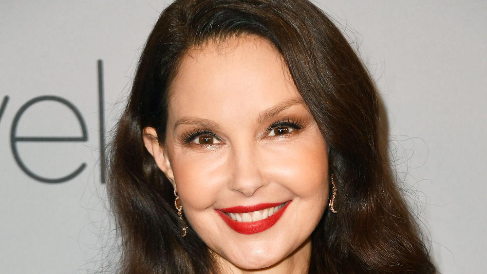 Ashley Judd smiling wearing red lipstick