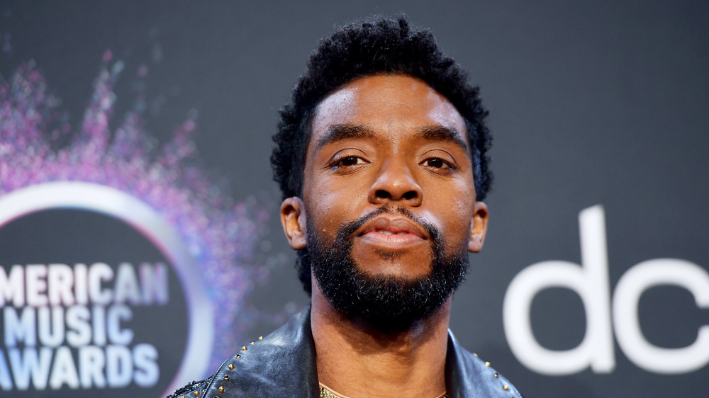 Chadwick Boseman in front of American Music Awards backdrop 