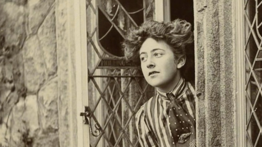 Agatha Christie as a young woman looking out a window