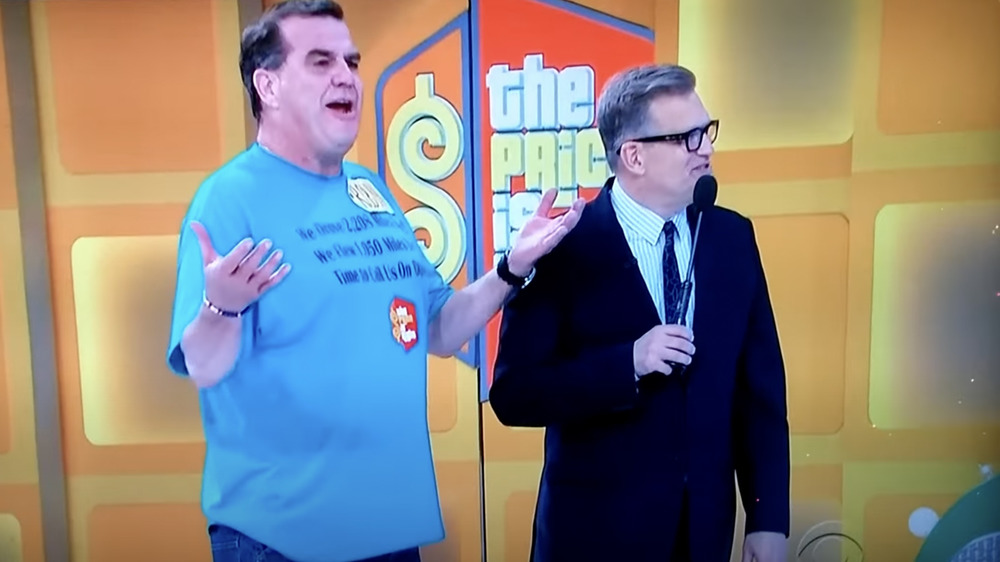 Drew Carey and contestant standing together