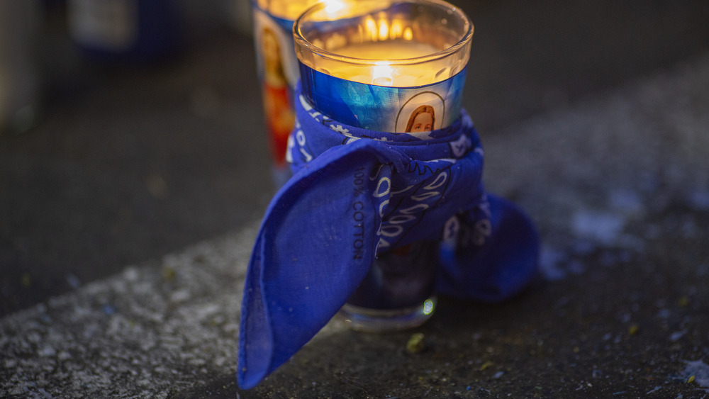 A blue bandana wrapped around a candle